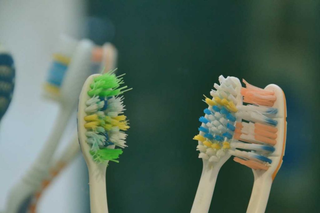 green yellow and blue manual toothbrushes