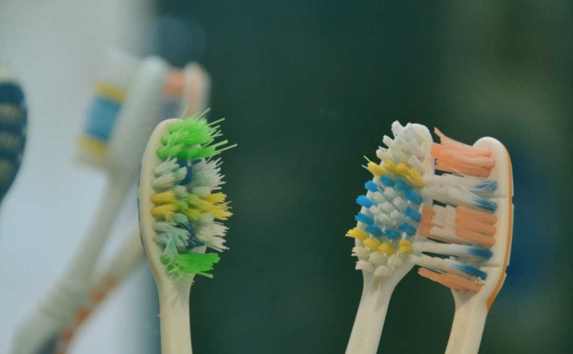 green yellow and blue manual toothbrushes