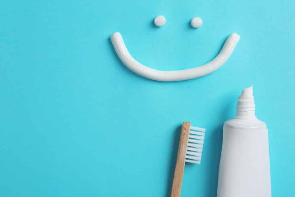 a toothpaste smiley face with toothpaste and toothbrush