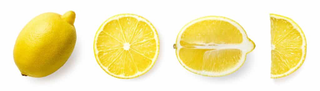 A lemon cut in 3 ways - in half width wise, in half length wise and in a quarter